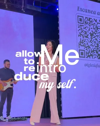 Fiorella speaking on stage at an event