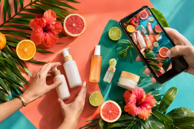 Styled product photo shoot of skincare, citrus and flowers captured on a phone